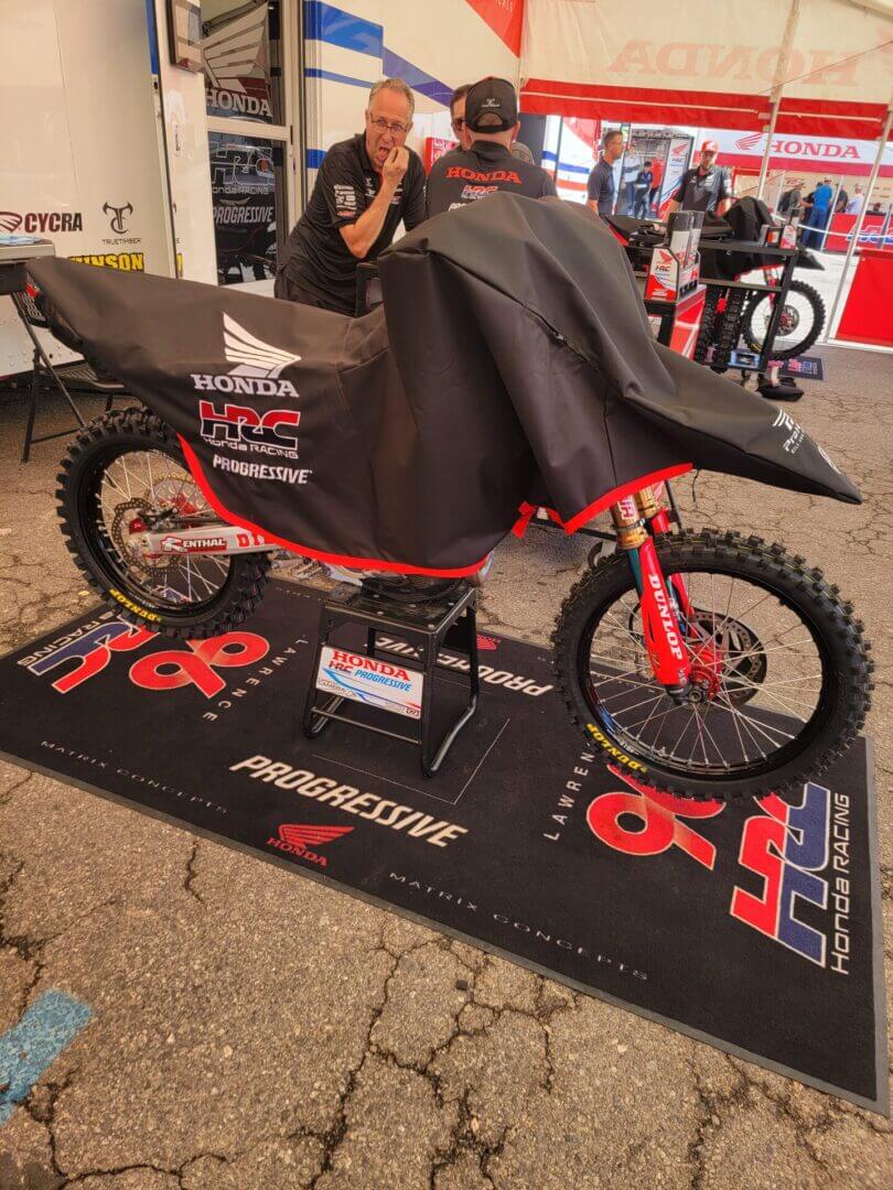 Covered motorcycle in Honda racing tent.