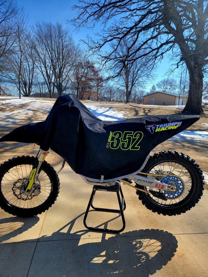 Covered dirt bike with neon 352 decal