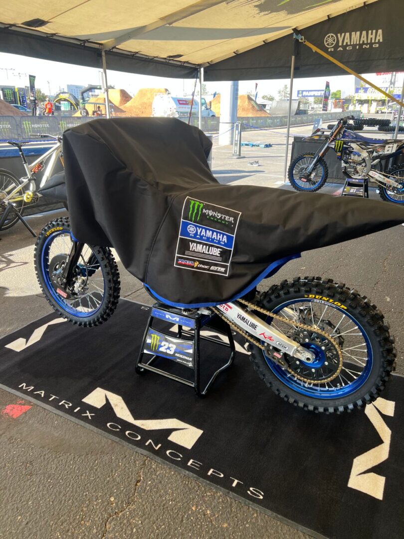 Covered Yamaha motocross bike on display stand