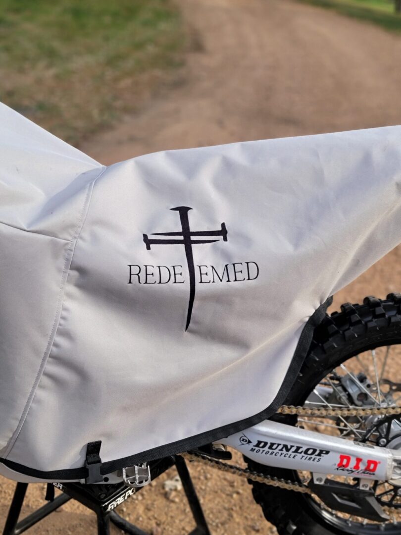 Motorcycle covered with "Redeemed" logo cover.